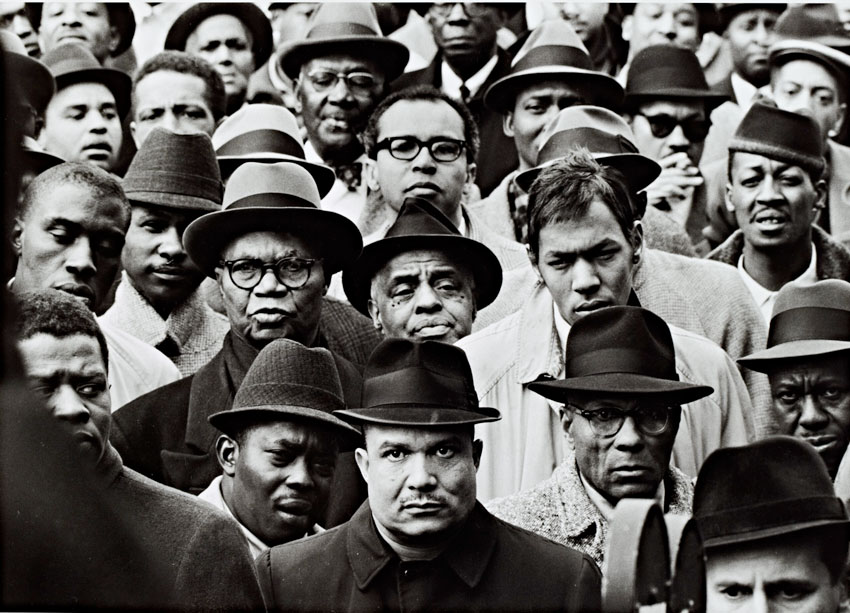A black and white photograph depicting several black Muslim men