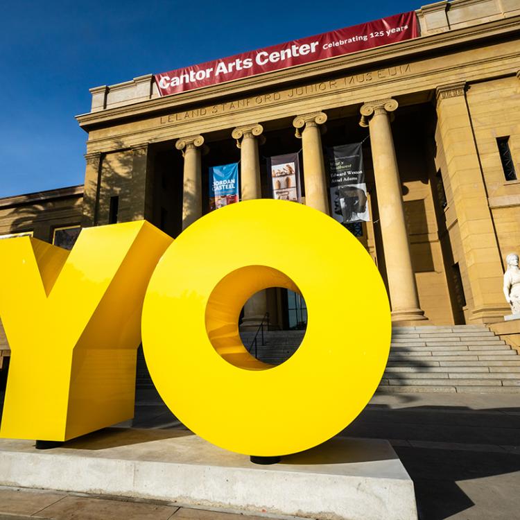 A yellow sculpture with the oversized letters Y and O