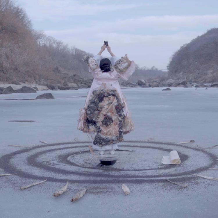 image of a person standing on a circle of sand