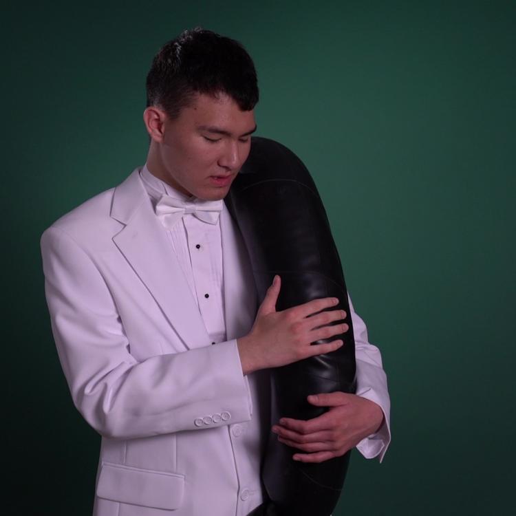 An image of a man on a white tuxedo on a green background