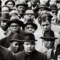A black and white photograph depicting several black Muslim men