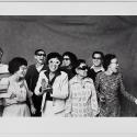A black and white photograph of people smiling and posing for the camera