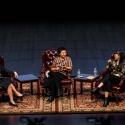 Three women on the stage during a symposium