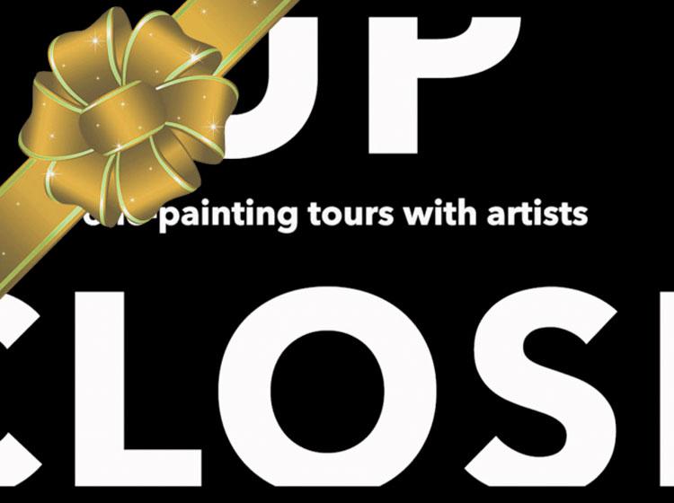 Up Close logo presented as a gift with a gold bow on it