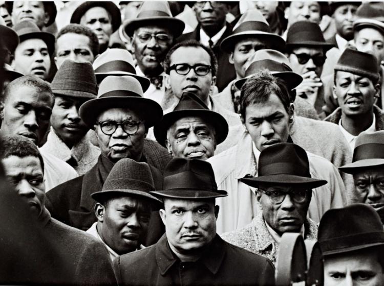 A black and white photograph depicting several black Muslim men