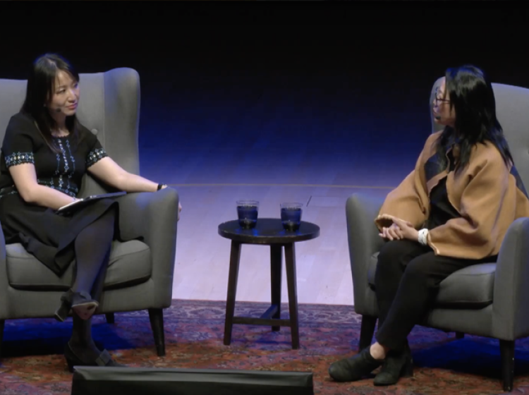 two women sitting down in conversation