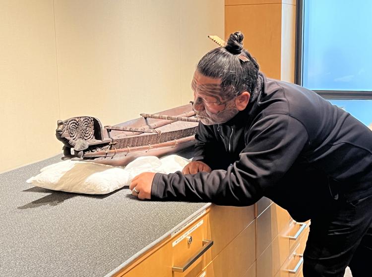 Man looking over artifact