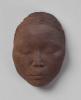 A color image of a clay portrait of artist Ruth Asawa and her husband Albert Lanier's son Paul Lanier.