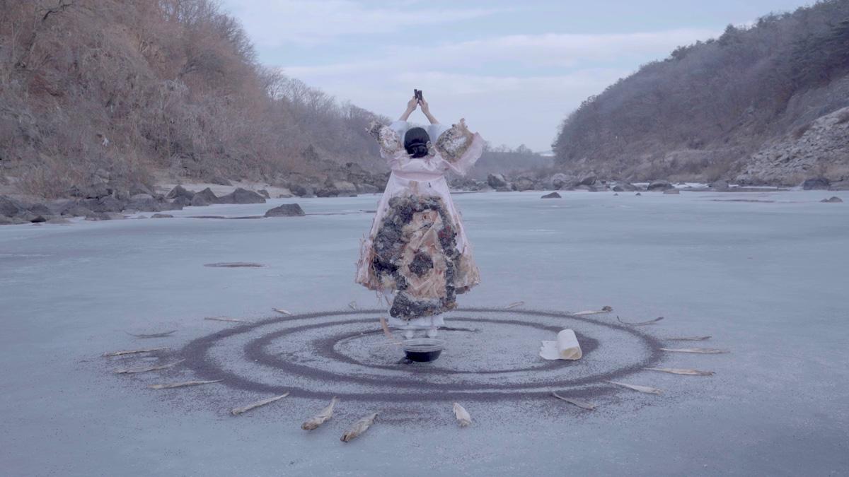 image of a person standing on a circle of sand