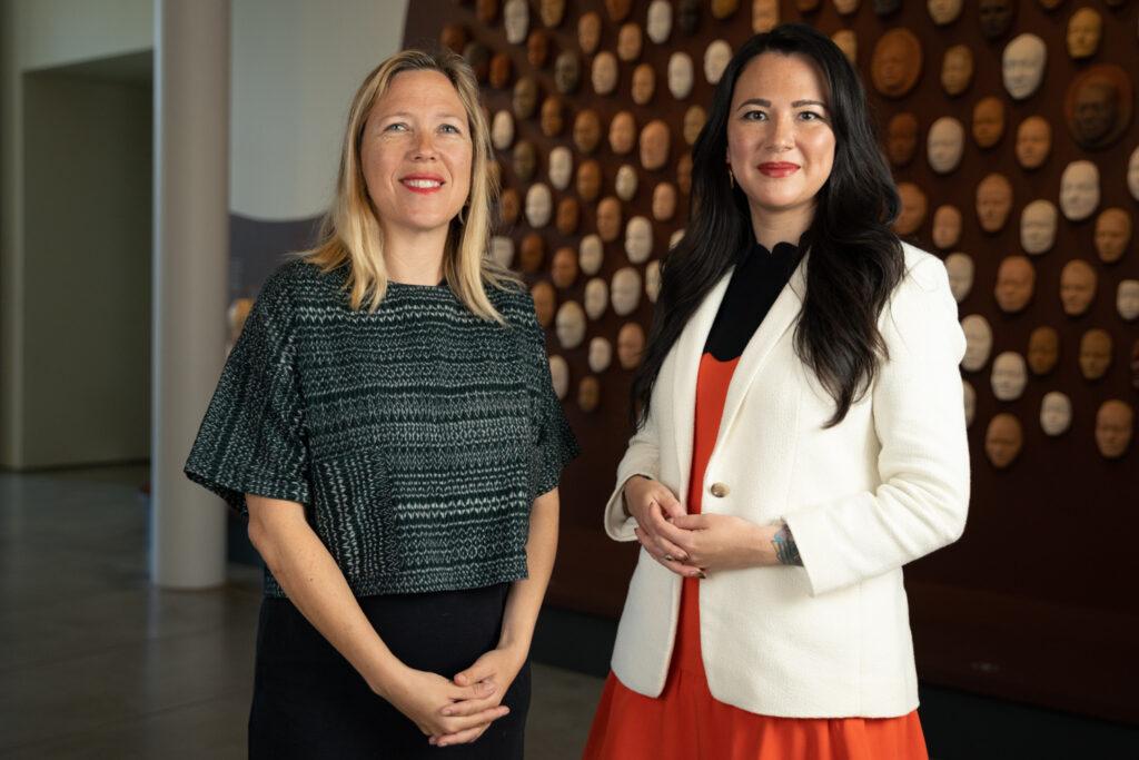 two women standing in an art gallery