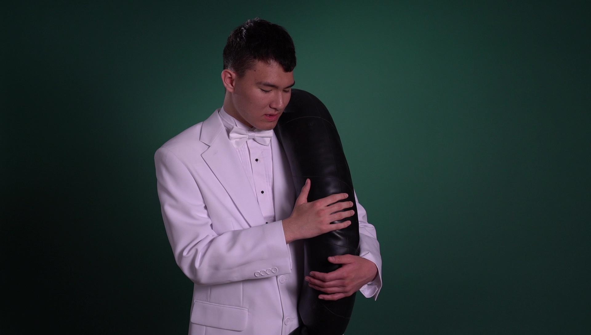 An image of a man on a white tuxedo on a green background