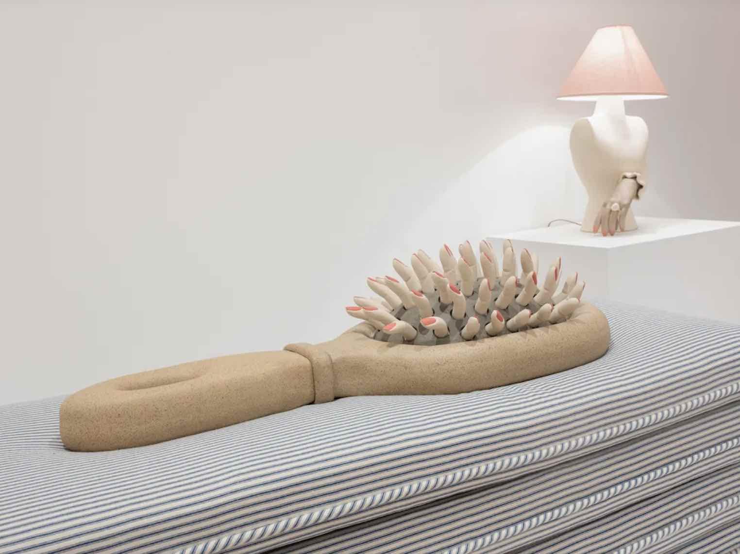 An image of a hair brush sitting on a cushion
