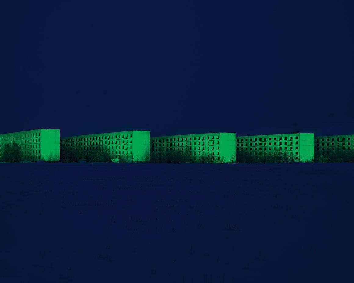 a blue background with green buildings